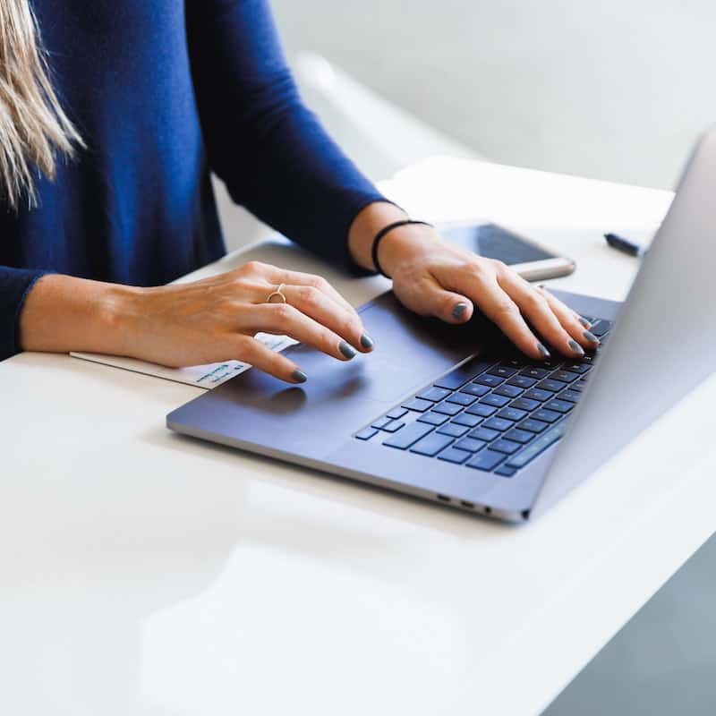 Woman typing on a laptop looking at an accountancy application.